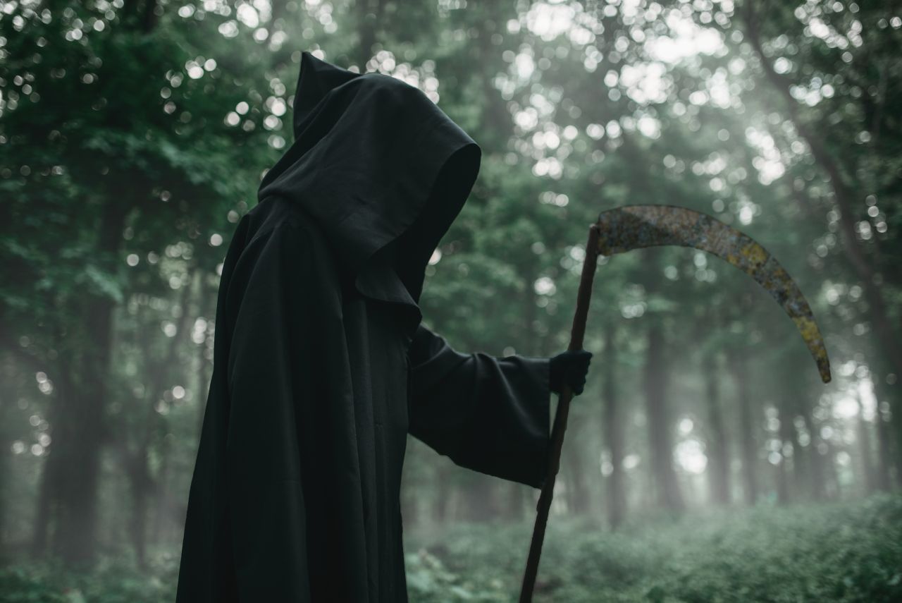 death-in-a-black-hoodie-with-a-scythe-in-forest-lhvswjg-1590405879.jpg