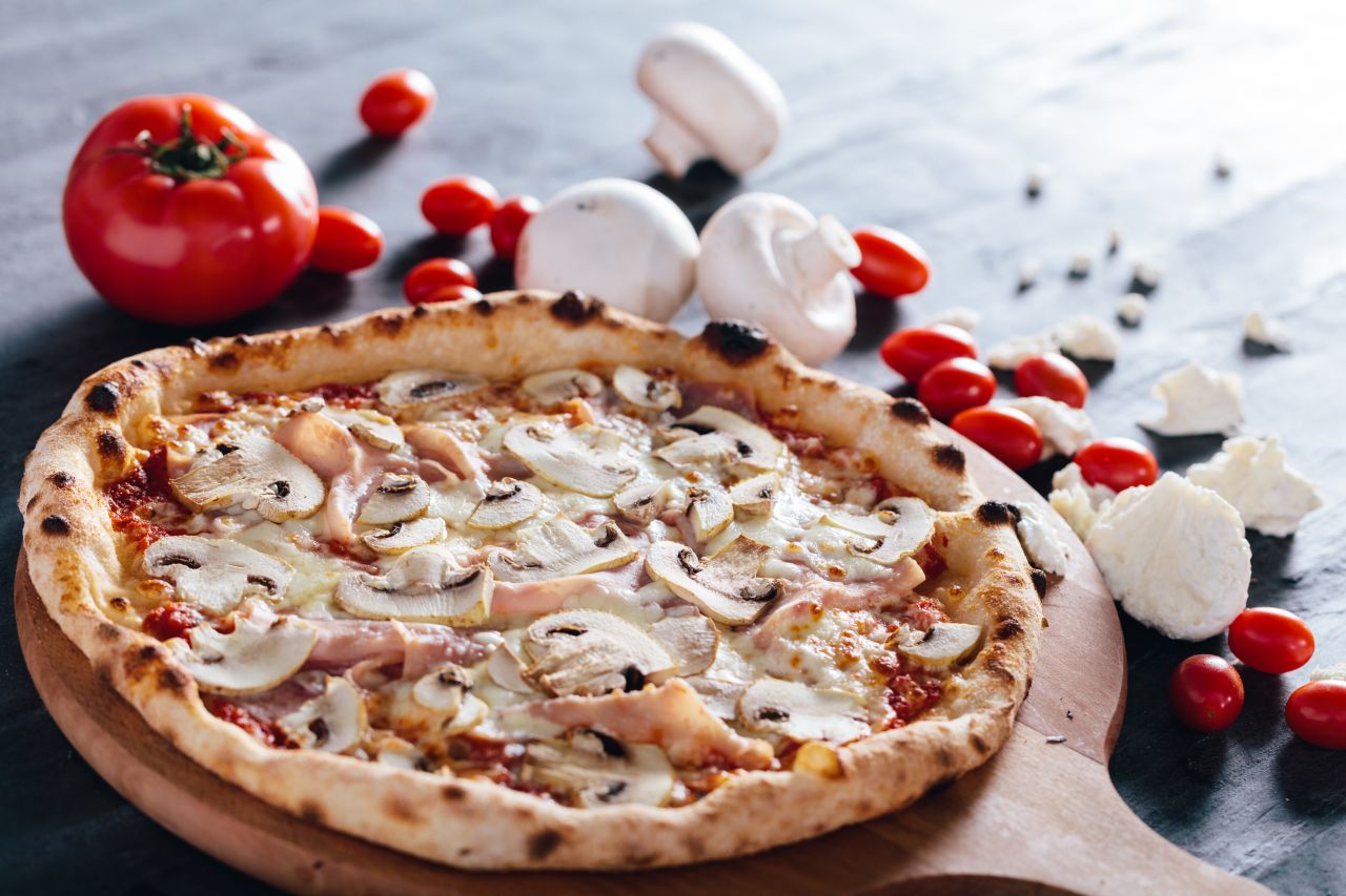 pizza-with-ham-mushrooms-and-mozzarella-on-wooden-trxj3g8-1-1584973345.jpg
