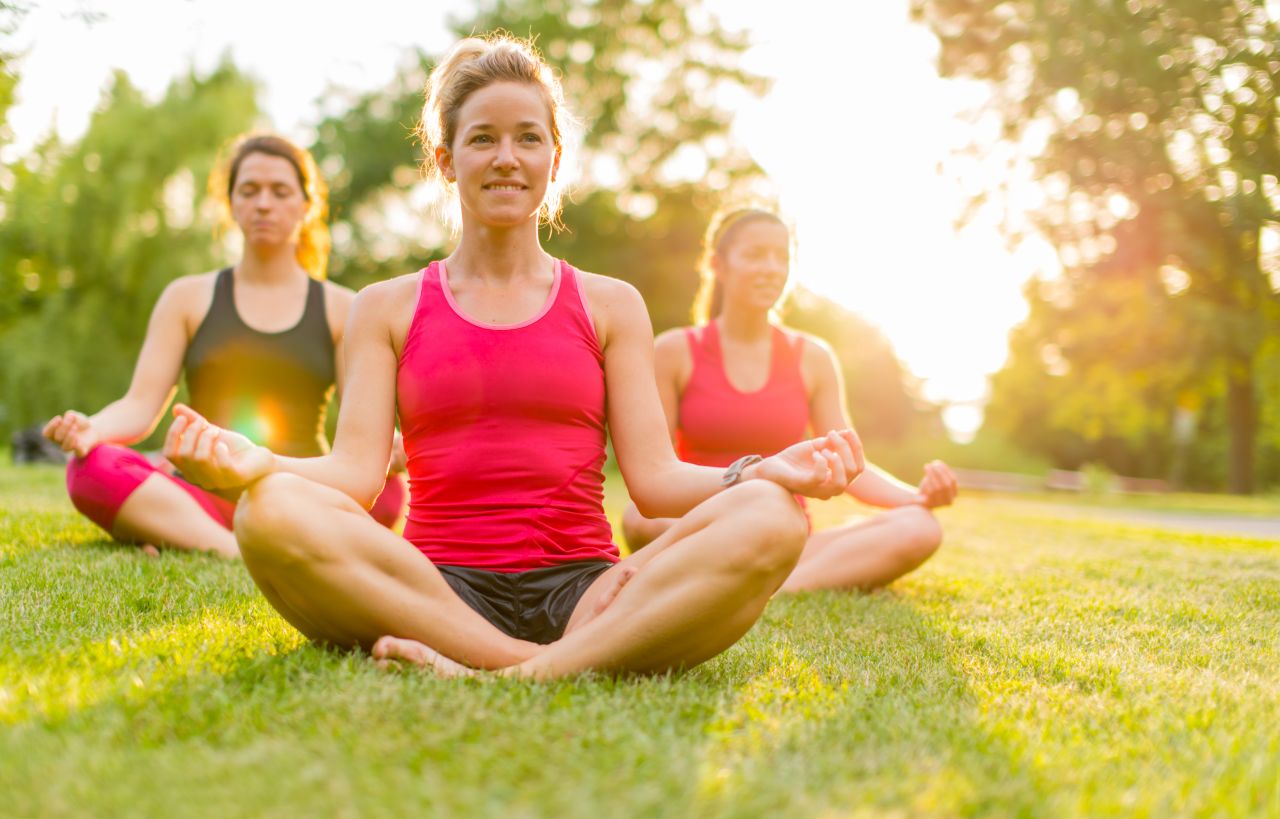 women-doing-yoga-outdoors-at-sunset-pgdy6m5-1583360331-1.jpg