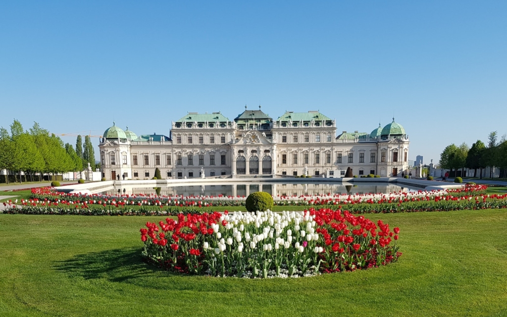 An Austrian Gallery Belvedere Near the Green Field with White and Red Flowers